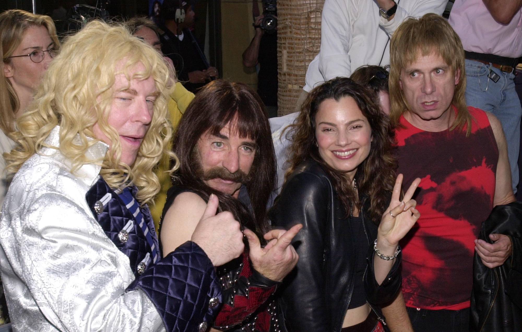 Actress Fran Drescher (second from right) poses for photographs with members of the band Spinal Tap. (Photo by Chris Weeks/Liaison)