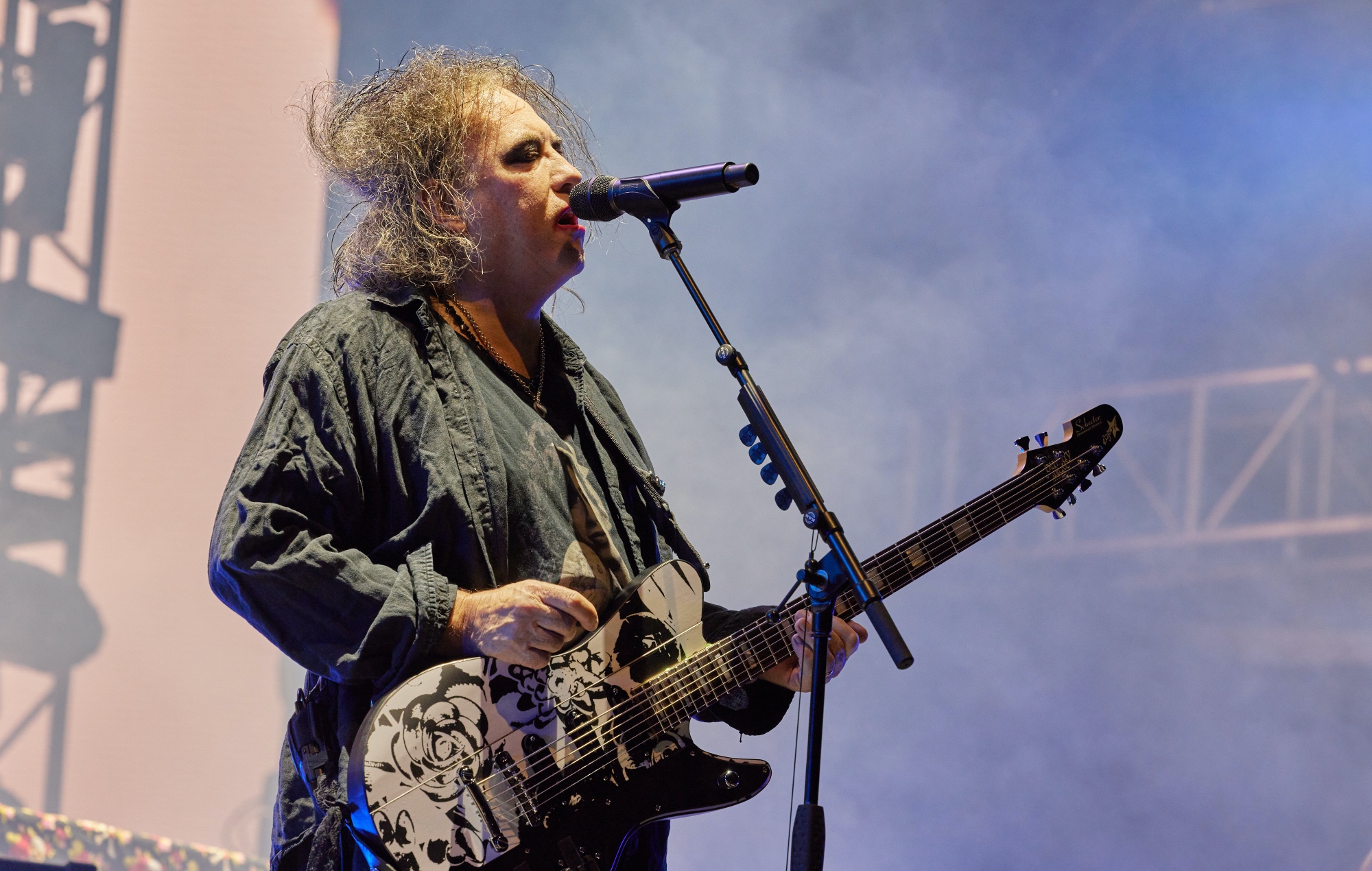 Robert Smith performs on stage with The Cure