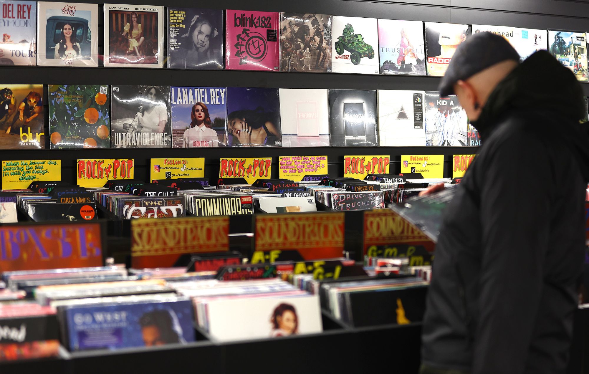 A customer browses a rack of vinyl records in London, 2023.