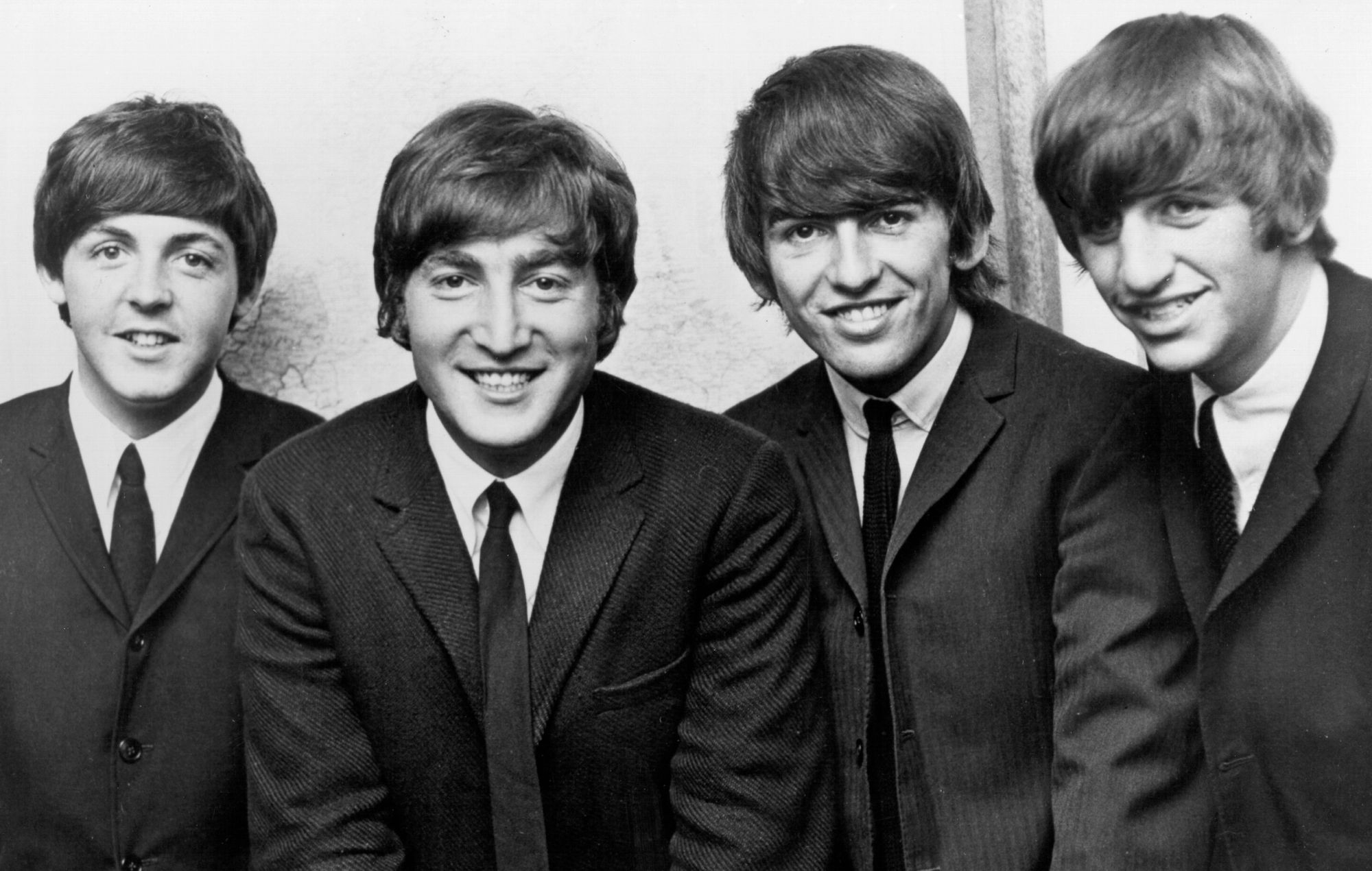 Beatles posing for a portrait around 1962.