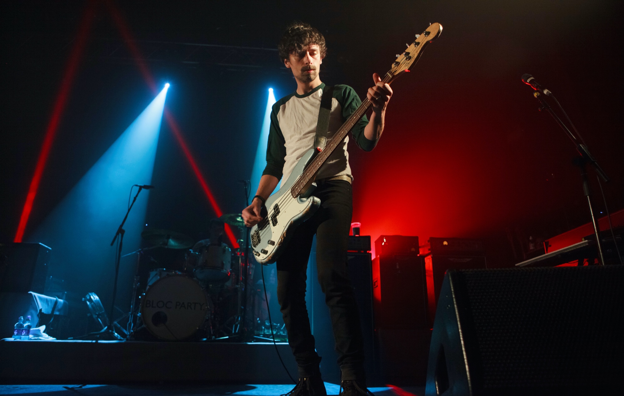 Gordon Moakes acts live on stage with Bloc Party